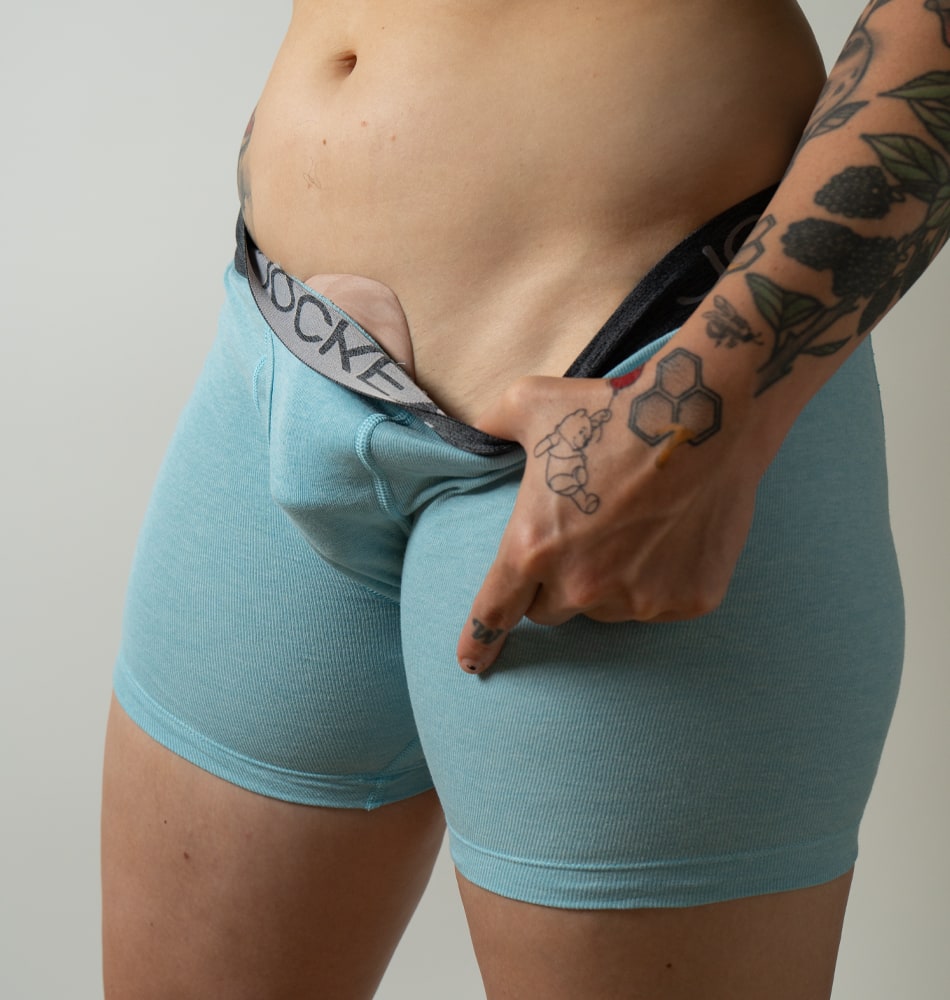 model revealing imprint in blue boxer briefs